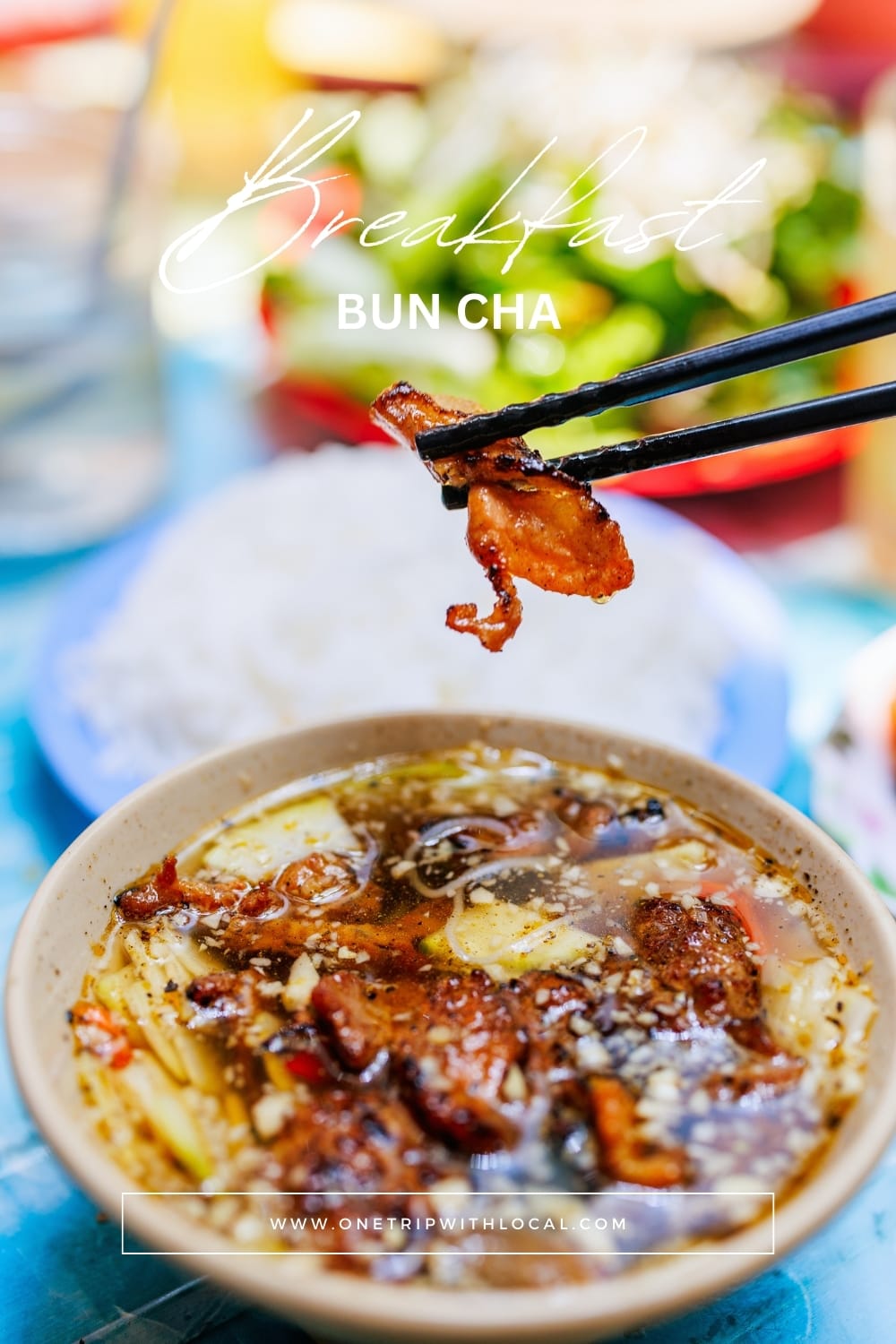 Fresh herbs and sides served with bun cha in Hanoi